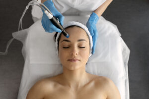 Female at cosmetic beauty spa clinic has facial hardware cosmetology