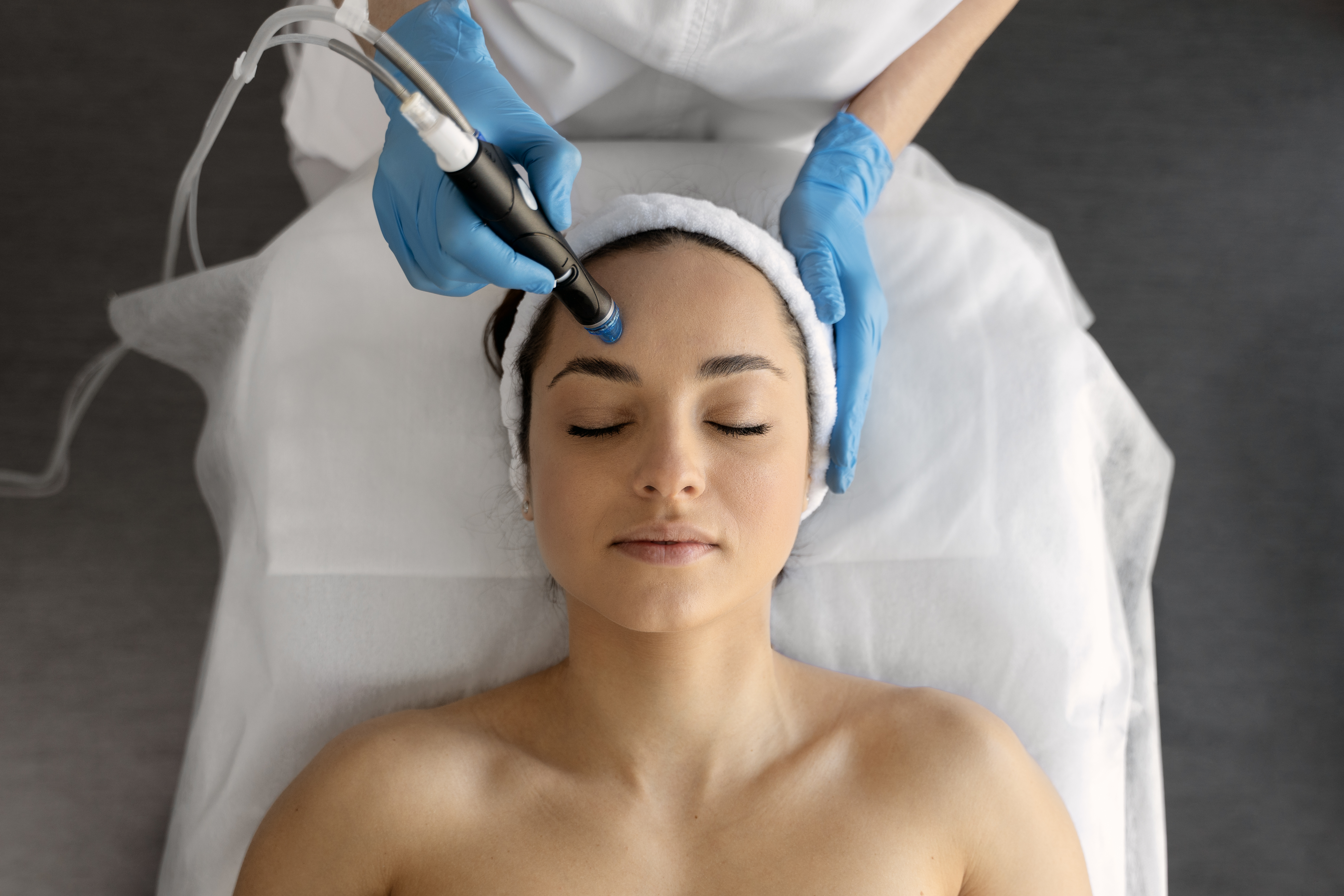 Female at cosmetic beauty spa clinic has facial hardware cosmetology